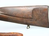 a rifle that is on display on a white background