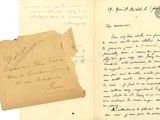 an old book with a piece of paper and a piece of paper with writing on it