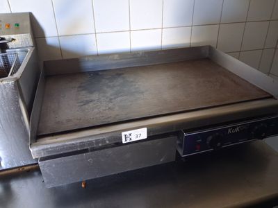 a large metal pan on a stove in a kitchen