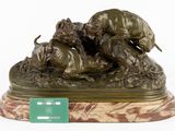 bronze sculpture of a lion attacking a bull on a marble base