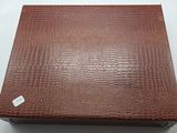 an image of a brown leather box with a label on it