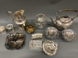 several silver and glass items are arranged on a table