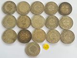 a bunch of coins sitting on top of a table next to a yellow coin
