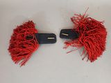 pair of red pom poms on a white surface