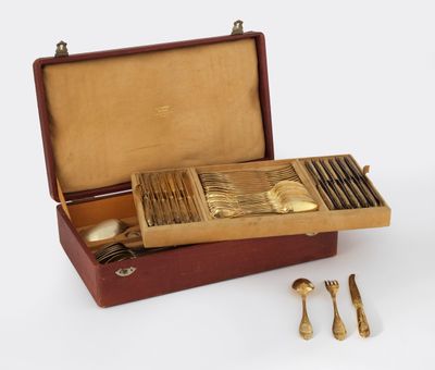 a wooden box with silverware in it on a white surface