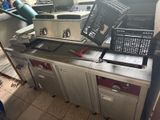 a kitchen with a bunch of baskets on top of the counter