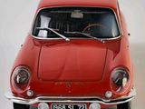 a red car that is sitting on a white surface