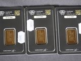three gold bars are sitting in a row on top of a table