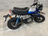 a blue and silver motorcycle parked in a parking lot