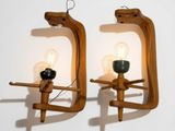 two wooden wall sconces with light bulbs on them