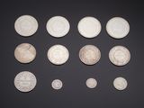 an assortment of silver coins on a black background