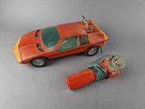 a toy car and a lighter on a table