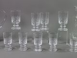 a lot of glasses and a pitcher on the table