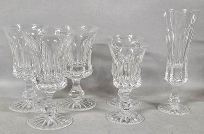 four glass goblets and a wine glass on a table