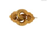 an image of a close up of a gold broochle on a white background