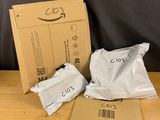 two bags of food sitting on a table next to a cardboard box