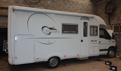 an image of a small camper in a garage