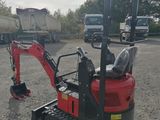 a small red excavator parked in a parking lot