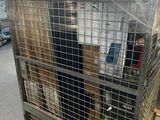 a large metal cage with a bunch of items in it