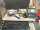 a computer desk with a keyboard and a monitor on it