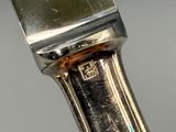 a close up of a knife with a metal handle