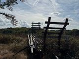 a wooden bench sitting in the middle of a field