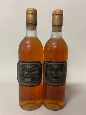 two bottles of alcohol sitting next to each other on a table
