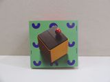 a box with a red button on it sitting on a table