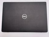 the dell laptop is sitting on a table with its lid open