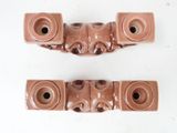 two pieces of brown pottery on a white surface
