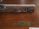 a gun that is on display on a table