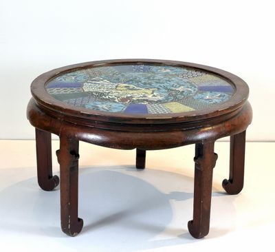 a wooden table with a mosaic top on it