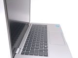 a silver laptop with a black keyboard on a white surface