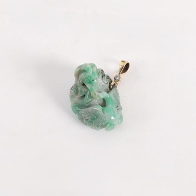 pendant of a green jade stone with a diamond in the middle