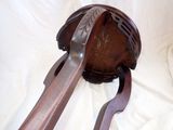 two wooden spoons and a wooden spoon rest on a white sheet