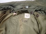 an image of a jacket with a tag on it sitting on a table