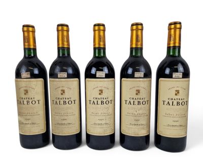 four bottles of red wine are lined up on a white surface