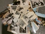 a pile of old photos on the floor of a room