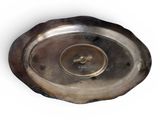 an image of a silver plate on a white surface with a white background