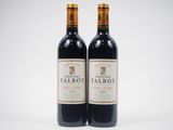two bottles of red wine sitting next to each other on a white surface
