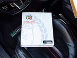 a picture of a box of pizza sitting in the driver ' s seat of a car