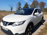 a white nissan qx parked on a dirt road