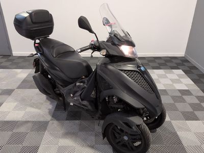 a picture of a black motorcycle parked in a room