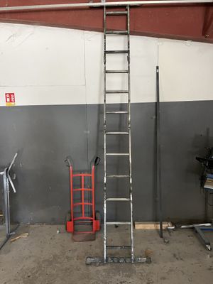 a ladder that is sitting in a garage next to a wall