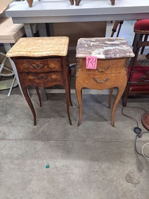 two tables that are sitting next to each other in a room