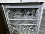 an open refrigerator with a bucket of food inside of it