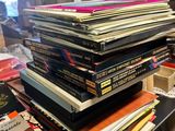 a lot of books stacked on a table in a room