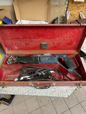 a red tool box with tools in it on the floor