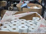 many rolls of toilet paper in a box in a room