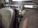 two seats in the back of a vehicle with a phone attached to it